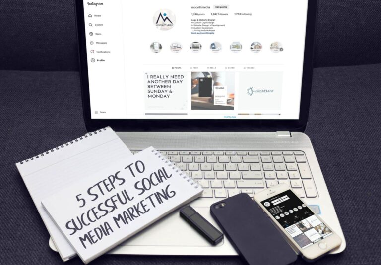 A notebook with “5 Steps to Successful Social Media Marketing” rests on a laptop displaying an Instagram page, alongside a smartphone and pen—perfect inspiration for businesses seeking web design services or custom website design by Moonlit Media.
