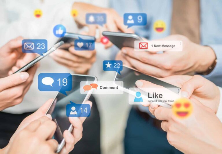 Several people holding smartphones, interacting with social media apps. Notifications for likes, messages, and followers overlay the scene, capturing active online engagement—perfect inspiration for any web designer or custom logo design project at Moonlit Media.