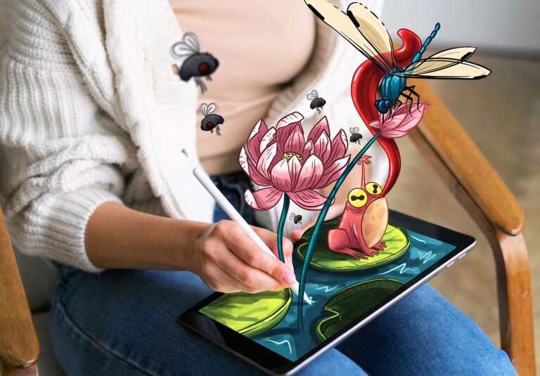 A person uses a stylus on a tablet, drawing vibrant, animated flowers, insects, and a frog that appear to emerge in 3D from the screen—showcasing Moonlit Media’s stunning custom logo design skills.