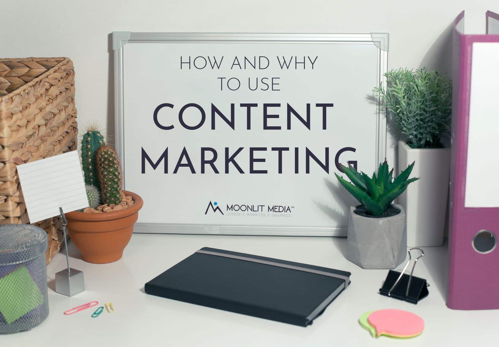 A whiteboard reading How and Why to Use Content Marketing is surrounded by office items, small plants, and supplies on a white desk. The logo Moonlit Media appears below the main text, highlighting their custom logo design expertise.