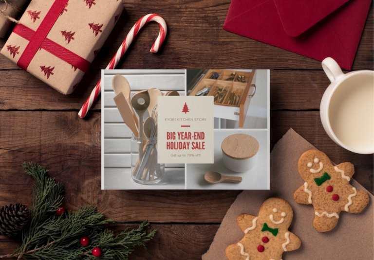 A holiday-themed flat lay with a gift box, candy cane, red envelopes, milk, gingerbread cookies, pine branches, and a flyer by Moonlit Media promoting a kitchen store’s year-end sale offering up to 70% off utensils.