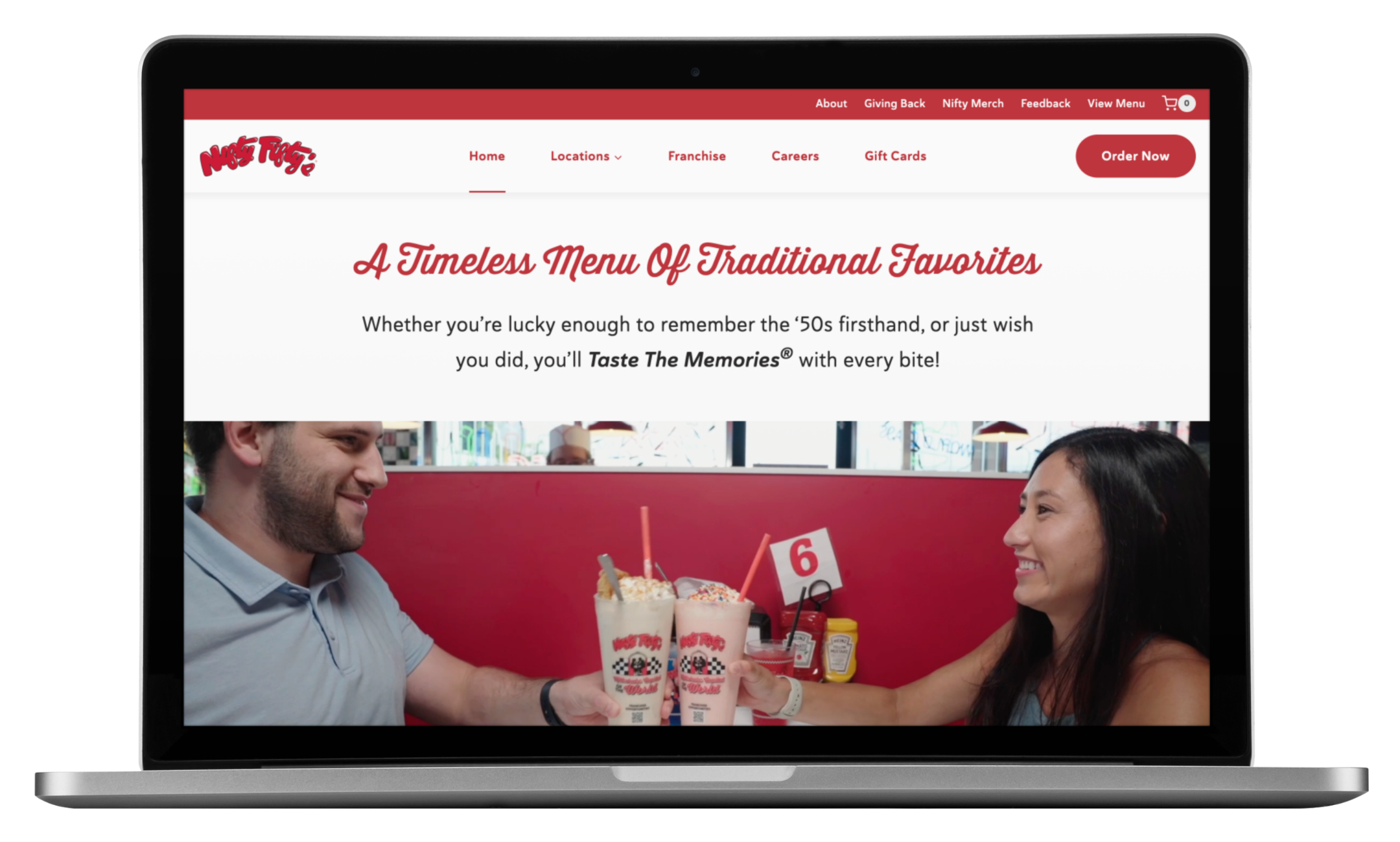 A laptop screen displays the Nifty Fiftys website for its New Hampshire diner, showing a smiling man and woman clinking milkshakes at a table. The site headline reads, A Timeless Menu Of Traditional Favorites, highlighting their recent website redesign.