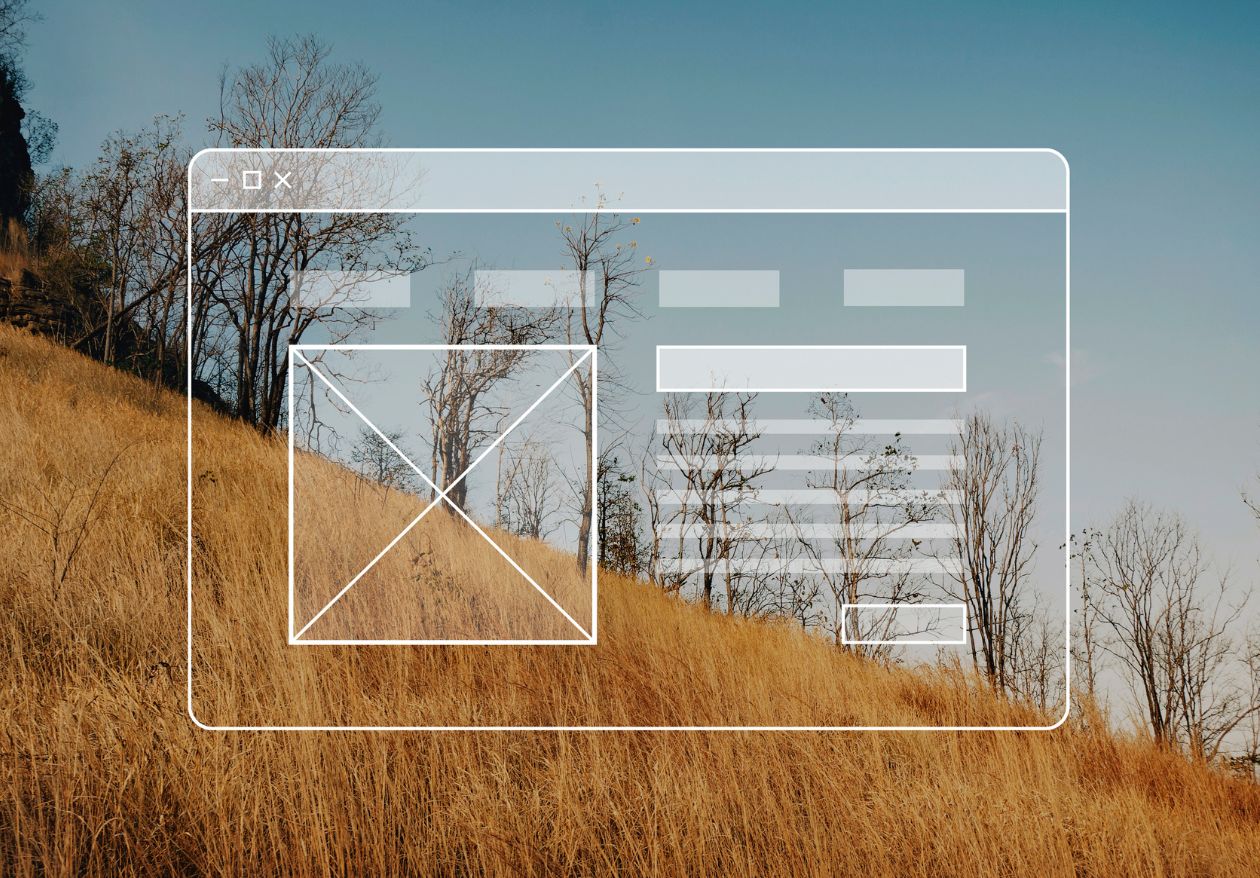 A wireframe of a website interface is overlaid on a photo of a dry grassy hillside with sparse, leafless trees under a clear blue sky, showcasing Moonlit Media’s expertise in custom logo design.