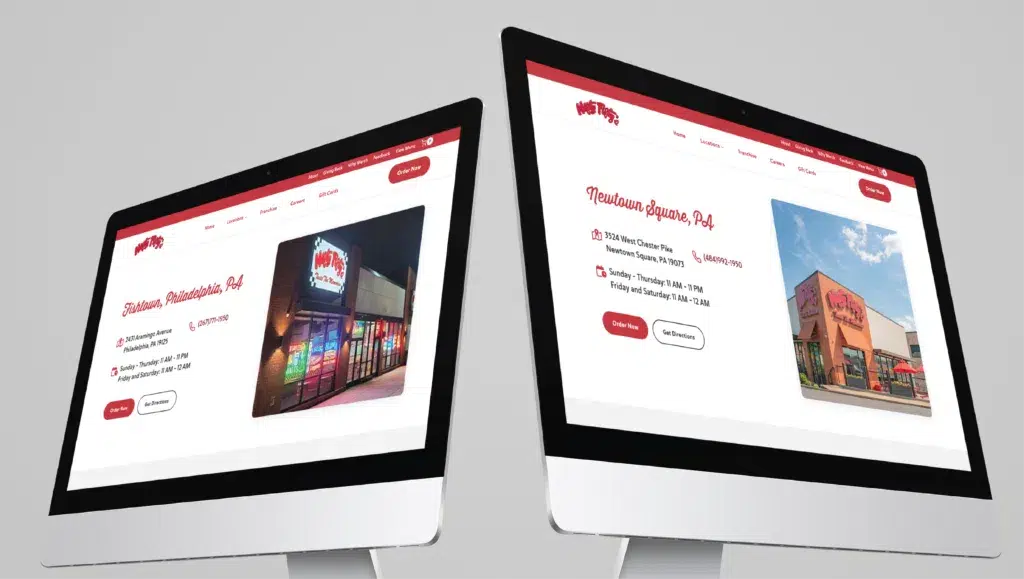 custom-website-design-for-restaurant-business-1024x579.png | Moonlit Media LLC Two computer monitors display different New Hampshire location pages of a restaurant's website, each featuring photos of exteriors, addresses, contact details, and operating hours on a light grey background after a recent website redesign.