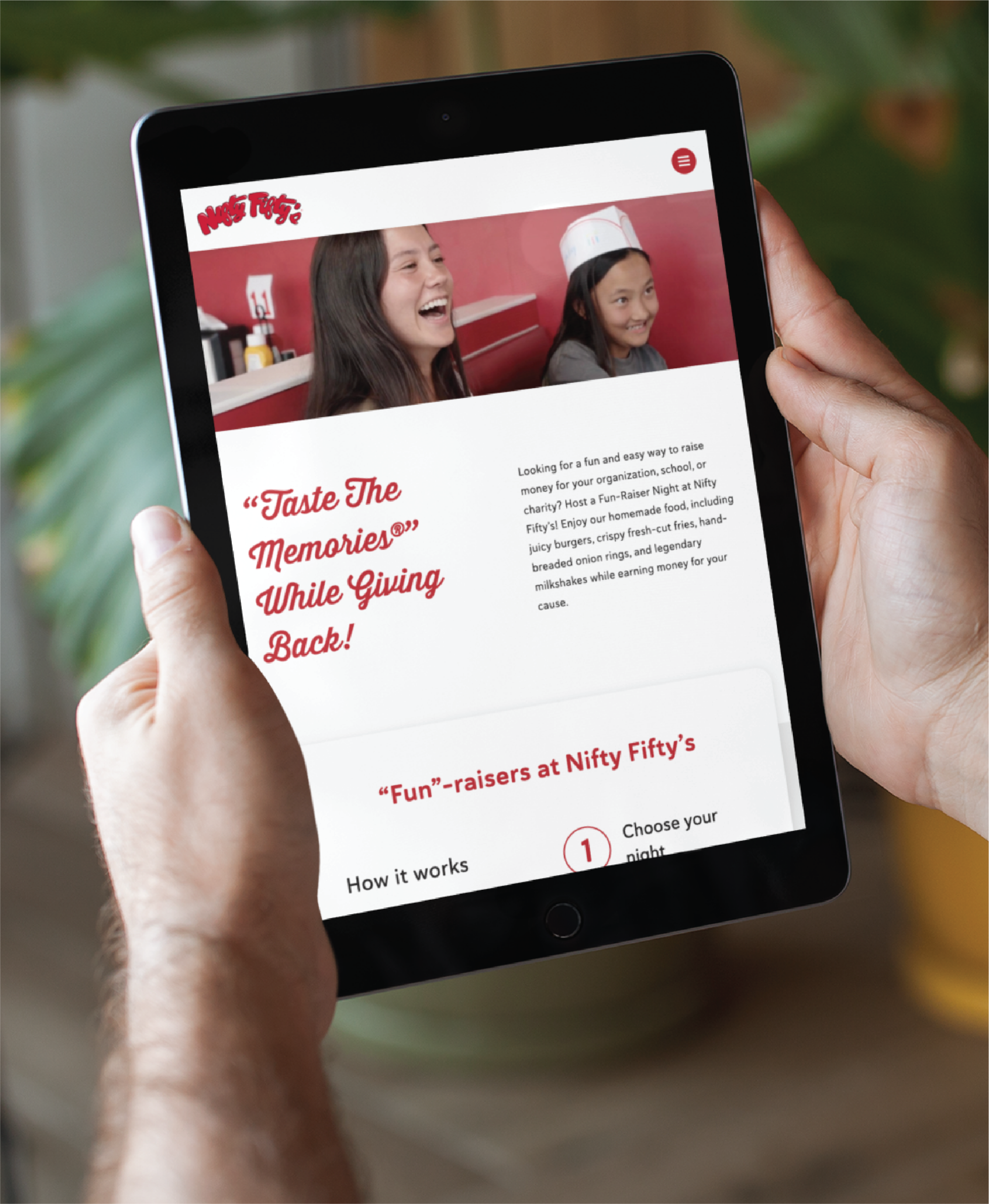 responsive-website-design-for-restaurant--scaled | Moonlit Media LLC A person holds a tablet displaying a newly redesigned website for Nifty Fifty’s fundraisers, featuring two smiling young women in a retro diner setting and text about supporting organizations in New Hampshire while enjoying nostalgic food.
