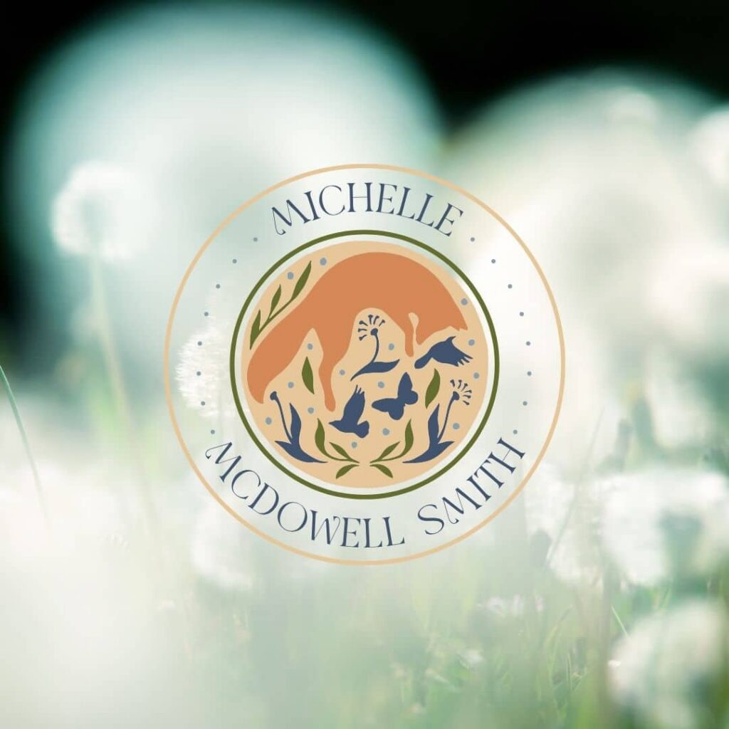 A circular logo by Moonlit Media featuring Michelle McDowell Smith encircling an illustration of a fox among plants and birds, set against a blurred background of white dandelions—showcasing expert logo design services.
