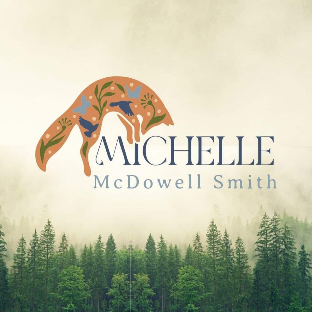 A stylized fox with floral designs forms an arch over the name “Michelle McDowell Smith” on a background of misty evergreen trees, capturing the artistry perfect for a web designer or those seeking custom website design inspiration.