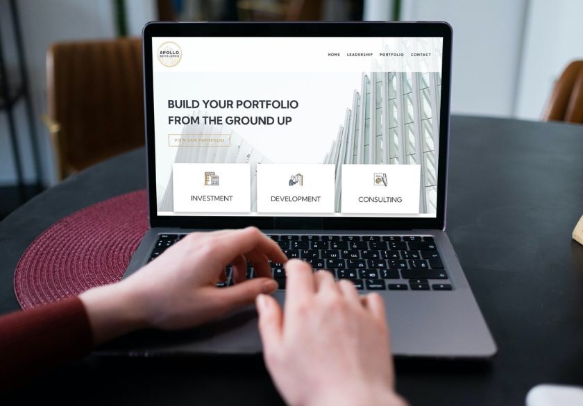 What clear actually means. A person uses a laptop displaying a website with the text Build your portfolio from the ground up and options for investment, development, and consulting—showcasing clarity in Marketing in 2026.