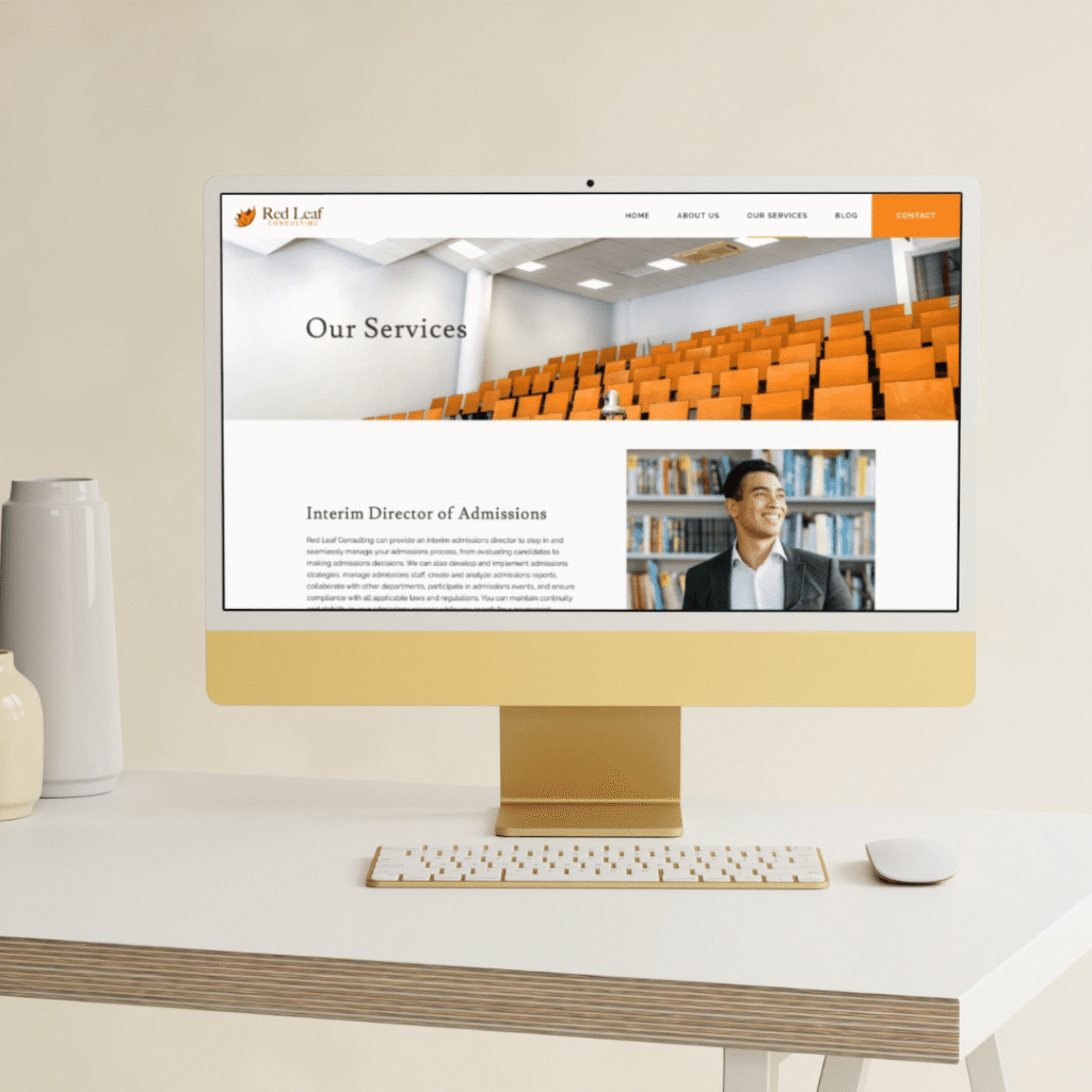 A computer on a desk displays a website page titled Our Services, featuring an image of an empty lecture hall and a photo of a smiling person with bookshelves, alongside text about admissions services by moonlit media, your expert web designer.