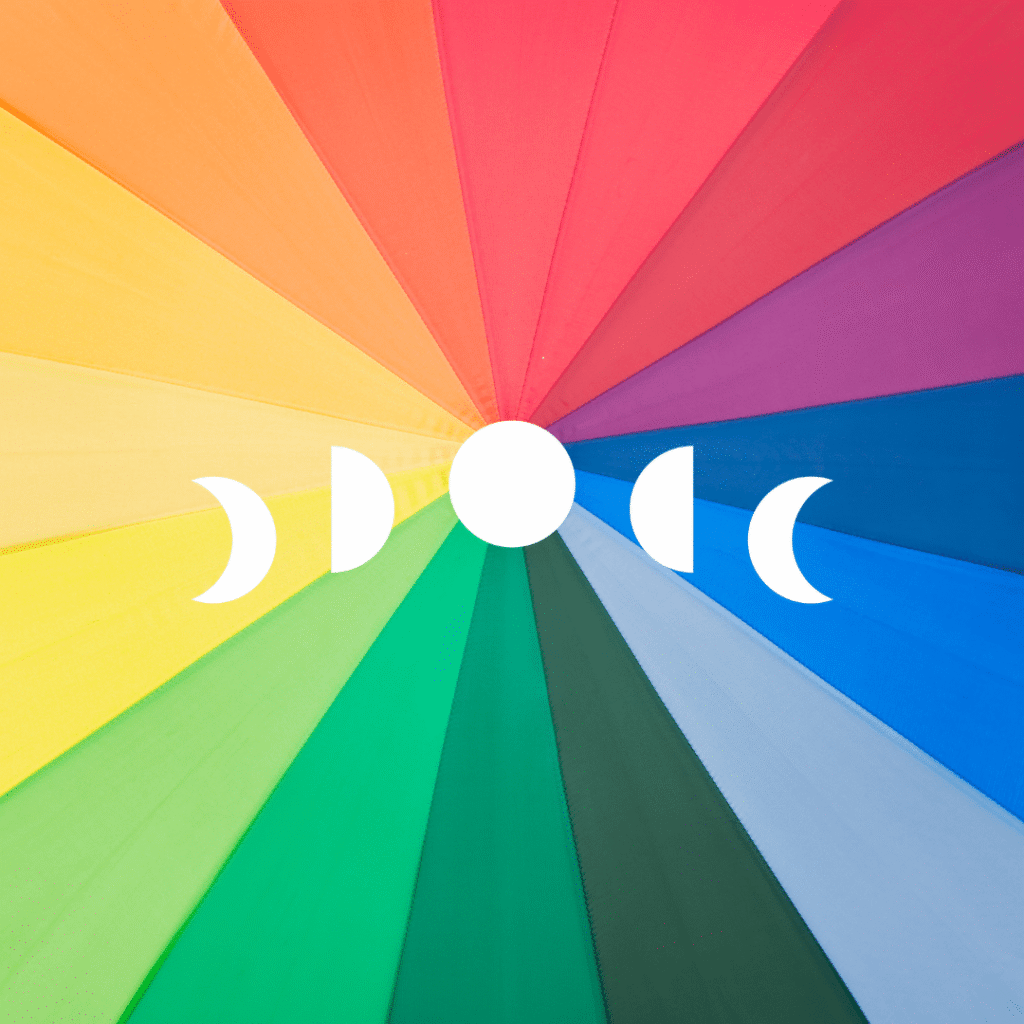 A radial rainbow pattern with vibrant color segments features a white lunar phase symbol—two crescent moons flanking a central full moon—centered on the image, reflecting the creativity of custom website design by Moonlit Media.
