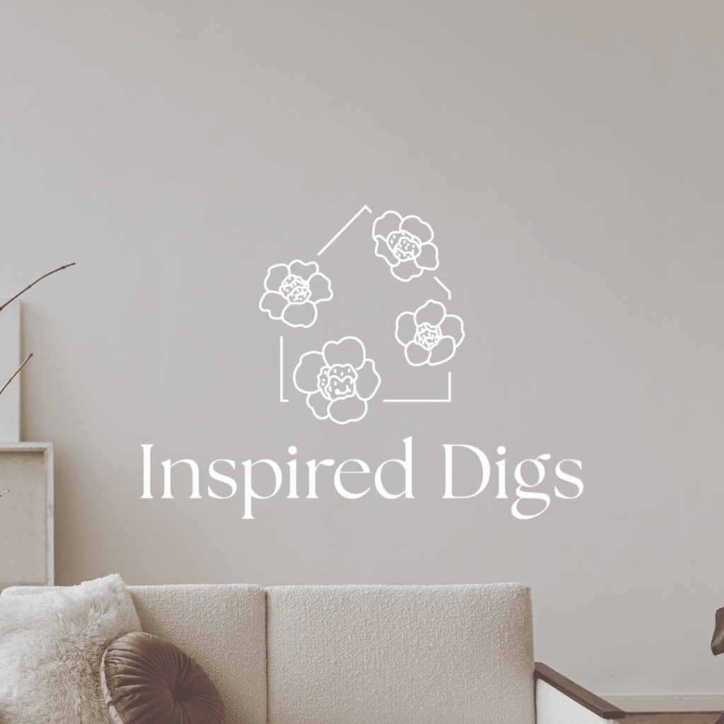 Beige living room with a white couch, brown pillow, and a minimalist floral logo above reading Inspired Digs on a light wall—perfect inspiration for those seeking custom logo design or professional logo design services.