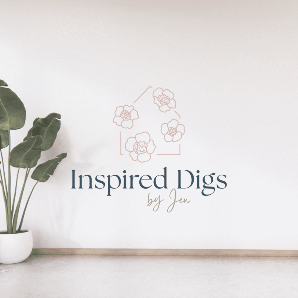 A minimalist room with a potted plant on the left and a wall logo that reads “Inspired Digs by Jen” below an outline of a house with flower illustrations, created by moonlit media, your trusted web designer.