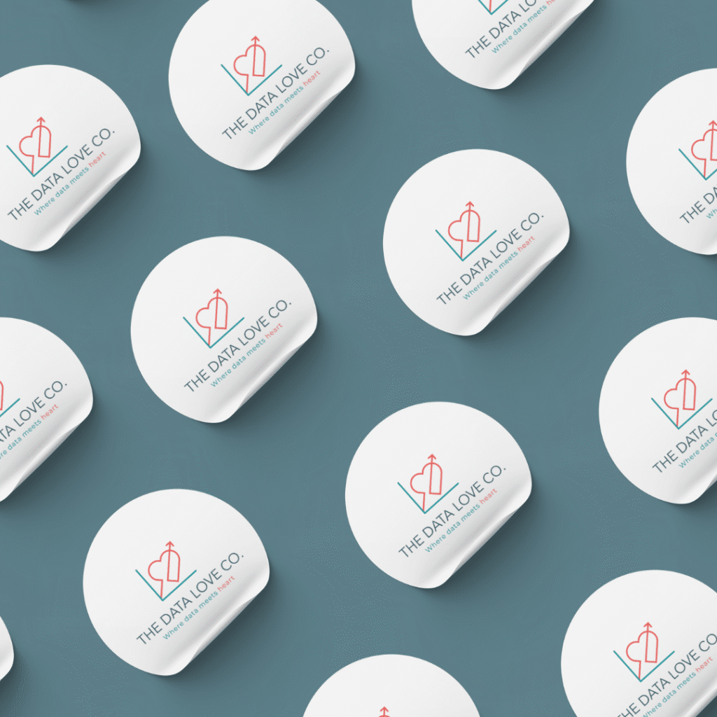 Multiple round white objects with THE DATA LOVE CO. logo and heart-shaped graphic are arranged in a diagonal repeating pattern on a teal background, showcasing the impact of standout logo design services.