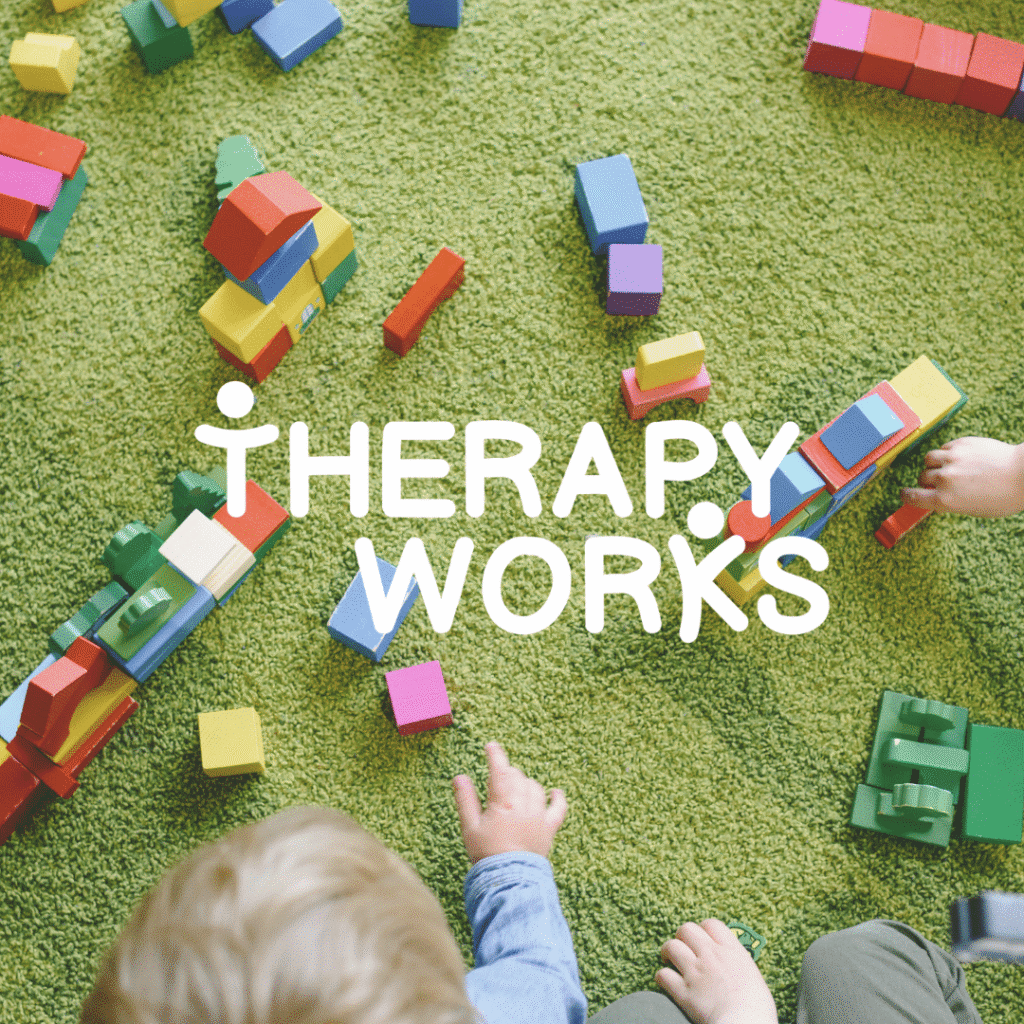 Children playing with colorful blocks on a green carpet, with THERAPY WORKS in bold white letters overlayed—an ideal image for web designers or those seeking custom logo design services to create engaging brands.