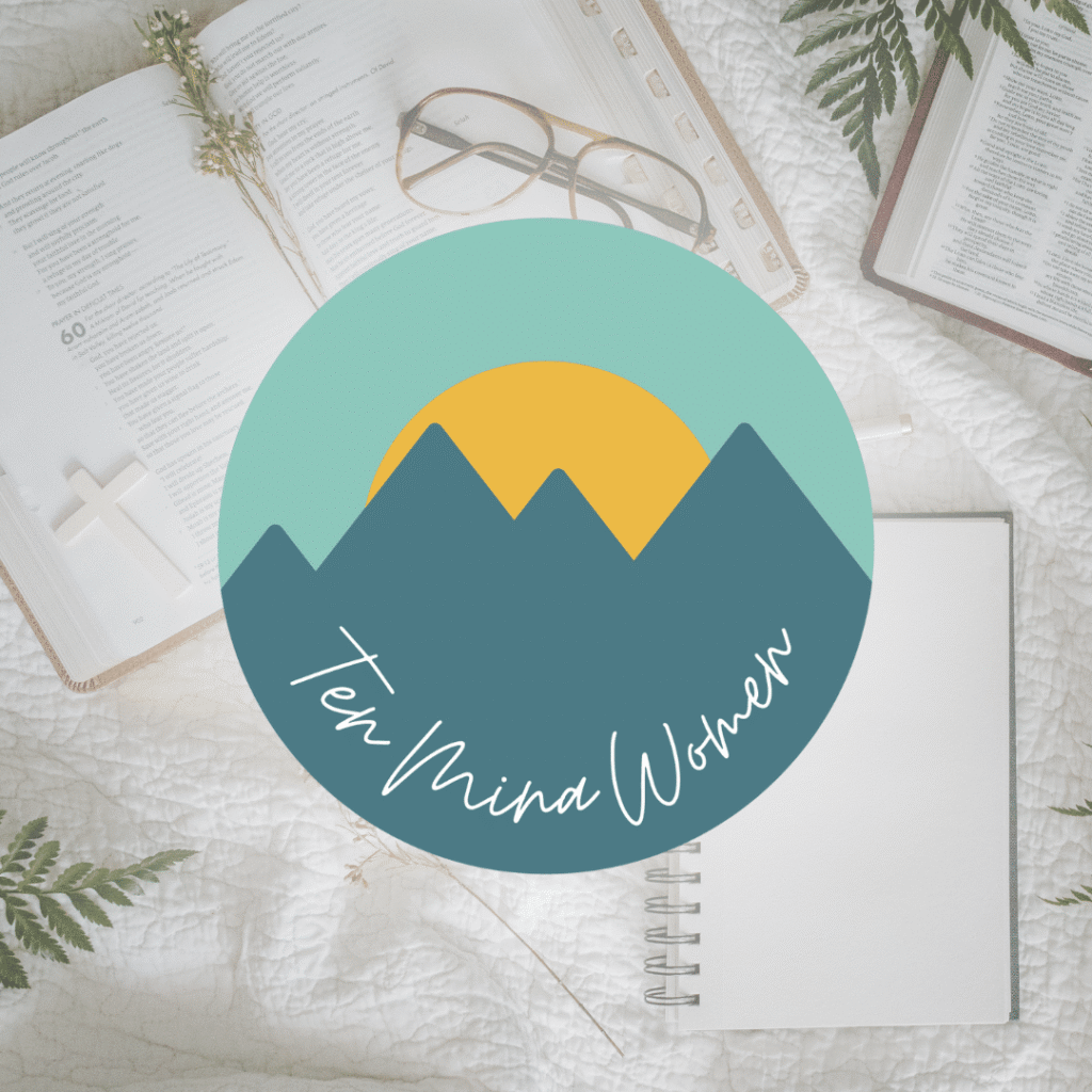 Open books, a journal, glasses, a pen, and green leaves rest on a white quilt. Centered is a custom logo design—a mountain and sun graphic with “Ten Mind Women” in cursive—perfect inspiration for any web designer or creative project.