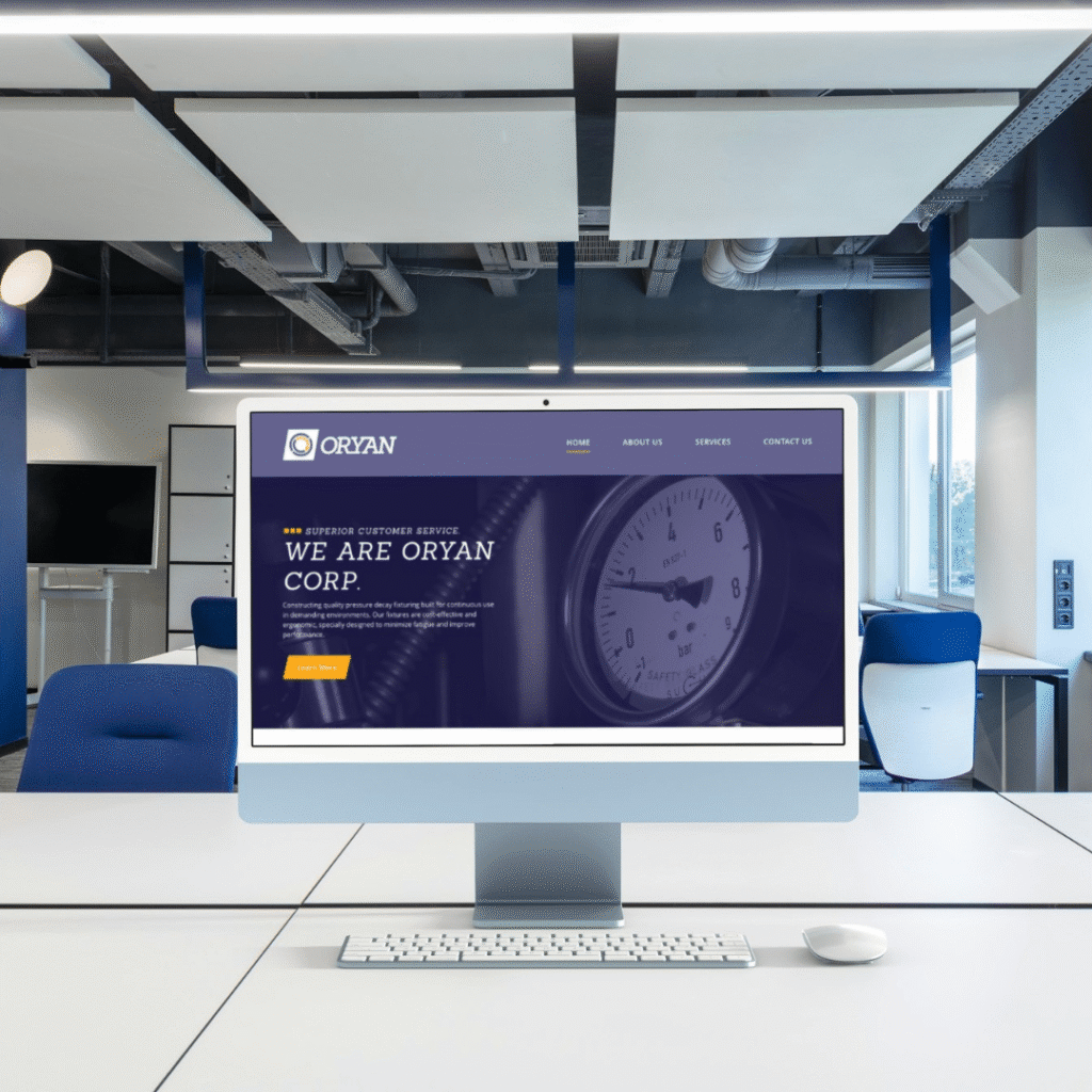 A modern office with a computer monitor on a white desk displays the ORYAN Corp. website, featuring their custom website design and a welcome message with a close-up image of a clock. Blue chairs and office equipment are visible in the background.