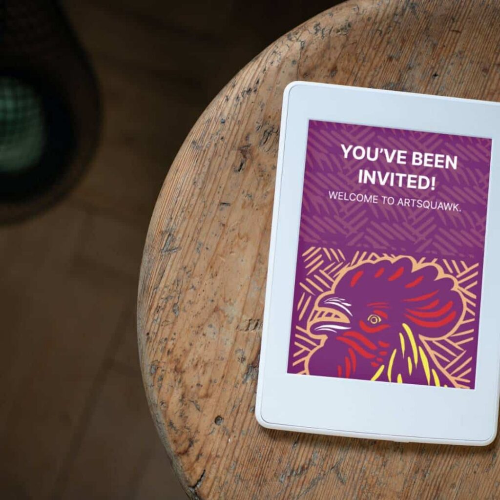 A tablet on a wooden table displays a colorful digital invitation with a stylized rooster illustration and the text “You’ve been invited! Welcome to ArtSquawk—your hub for custom logo design and creative inspiration.”.