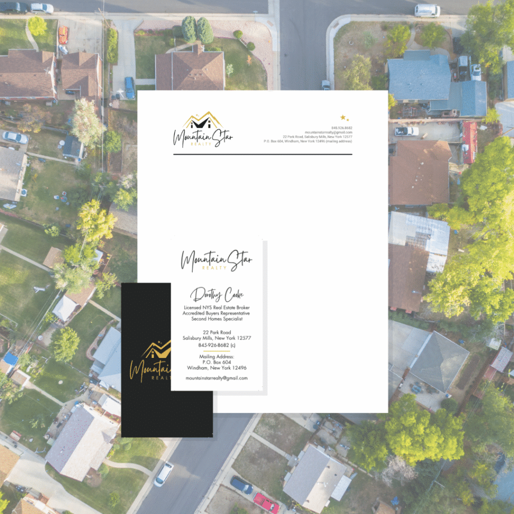 Flat lay of Mountain Star Realty stationery, featuring a letterhead, business card, and contact card—showcasing their custom logo design—displayed over an aerial view of a suburban neighborhood with houses, trees, and streets.