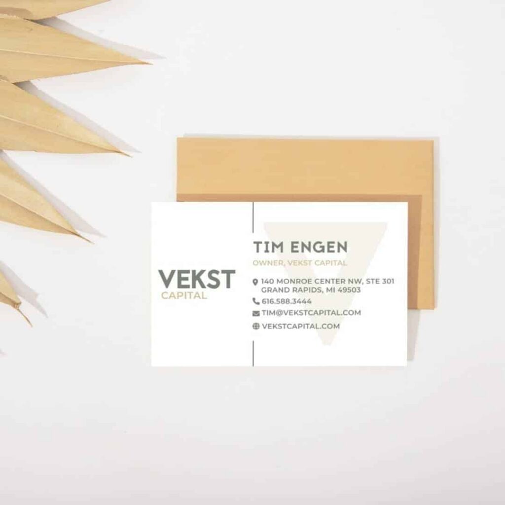 A business card for Tim Engen, owner of Vekst Capital, placed on a white surface near a brown envelope and dried palm leaves. The card, designed by Moonlit Media, displays contact details and the Vekst Capital logo.