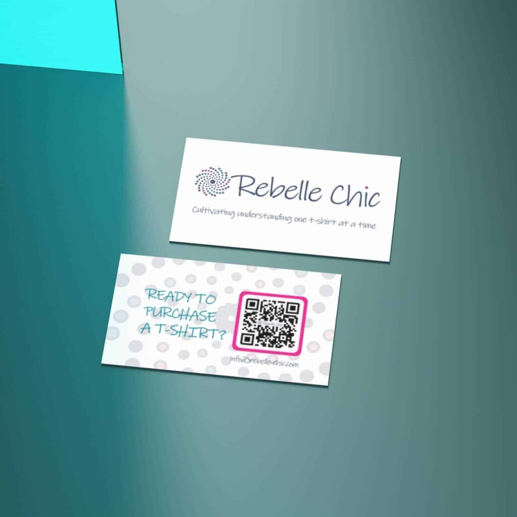 Two business cards on a teal surface. The top card reads Rebelle Chic: Cultivating understanding one t-shirt at a time. The bottom card, featuring a QR code, invites you to purchase and highlights our custom website design services.