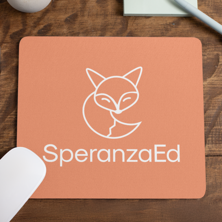 A peach-colored mouse pad with a white minimalist fox logo above the text SperanzaEd—perfect for branding—sits on a wooden desk next to a computer mouse, pen, and paper, ideal for educational consultants or website design professionals.