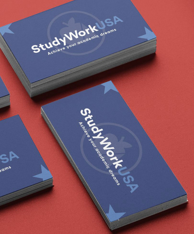 Close-up of colorful business cards arranged neatly on a workspace, showcasing a professional studio environment.