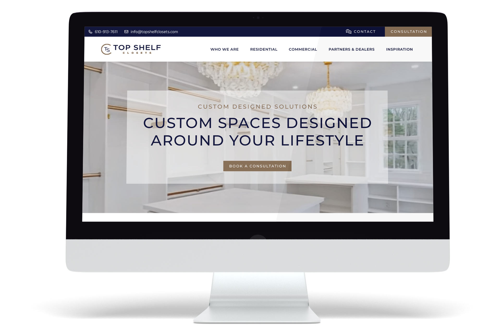 A computer monitor displays the Top Shelf Closets website design, featuring a modern white closet and the text, Custom spaces designed around your lifestyle, with a button labeled Book a Consultation.
