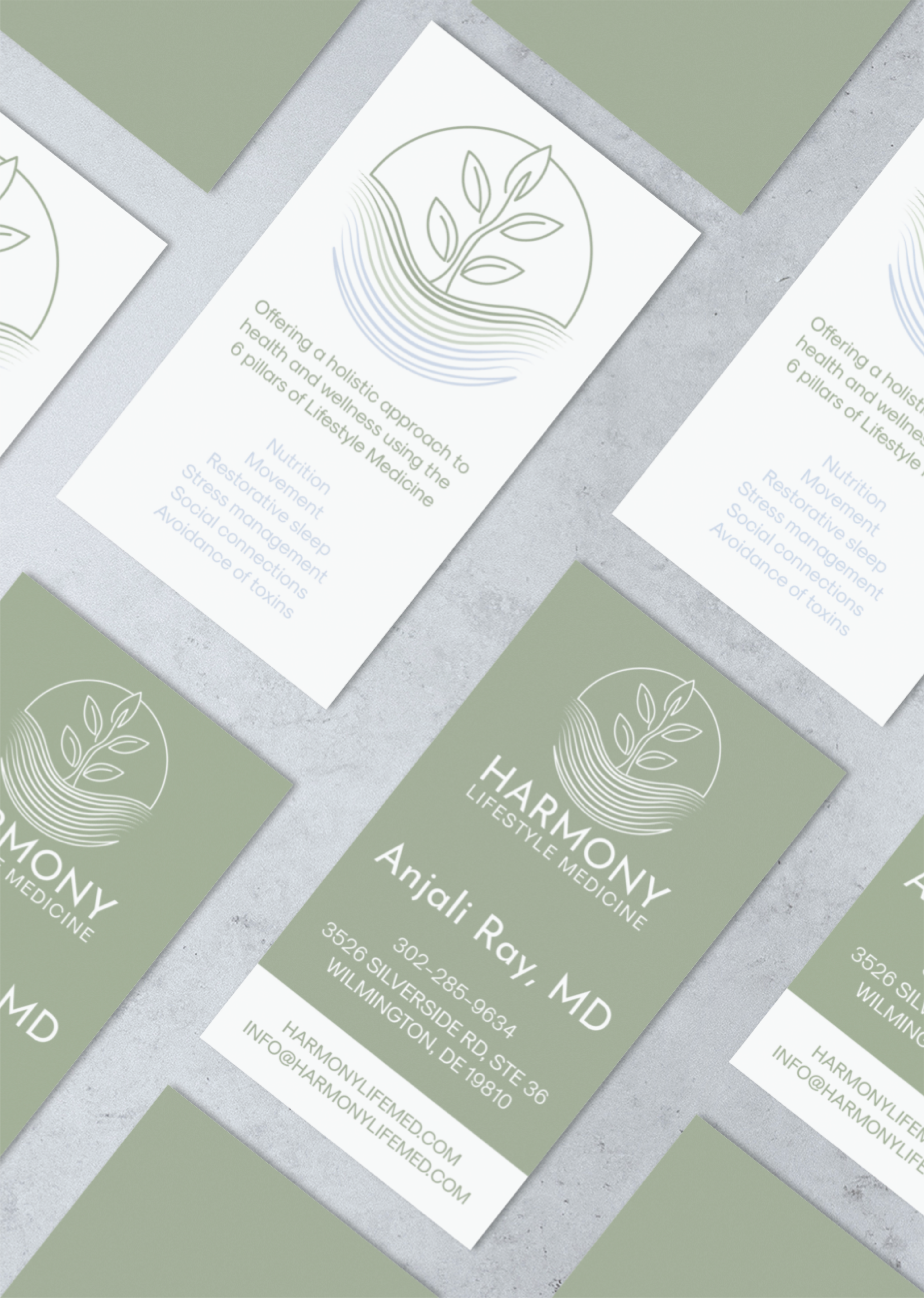 | Moonlit Media LLC Business cards for “Harmony Lifestyle Medicine” arranged on a gray surface. The green and white branding features a leaf logo and contact details for Anjali Ray, MD—perfect for lifestyle coaches looking to connect or enhance their website design.