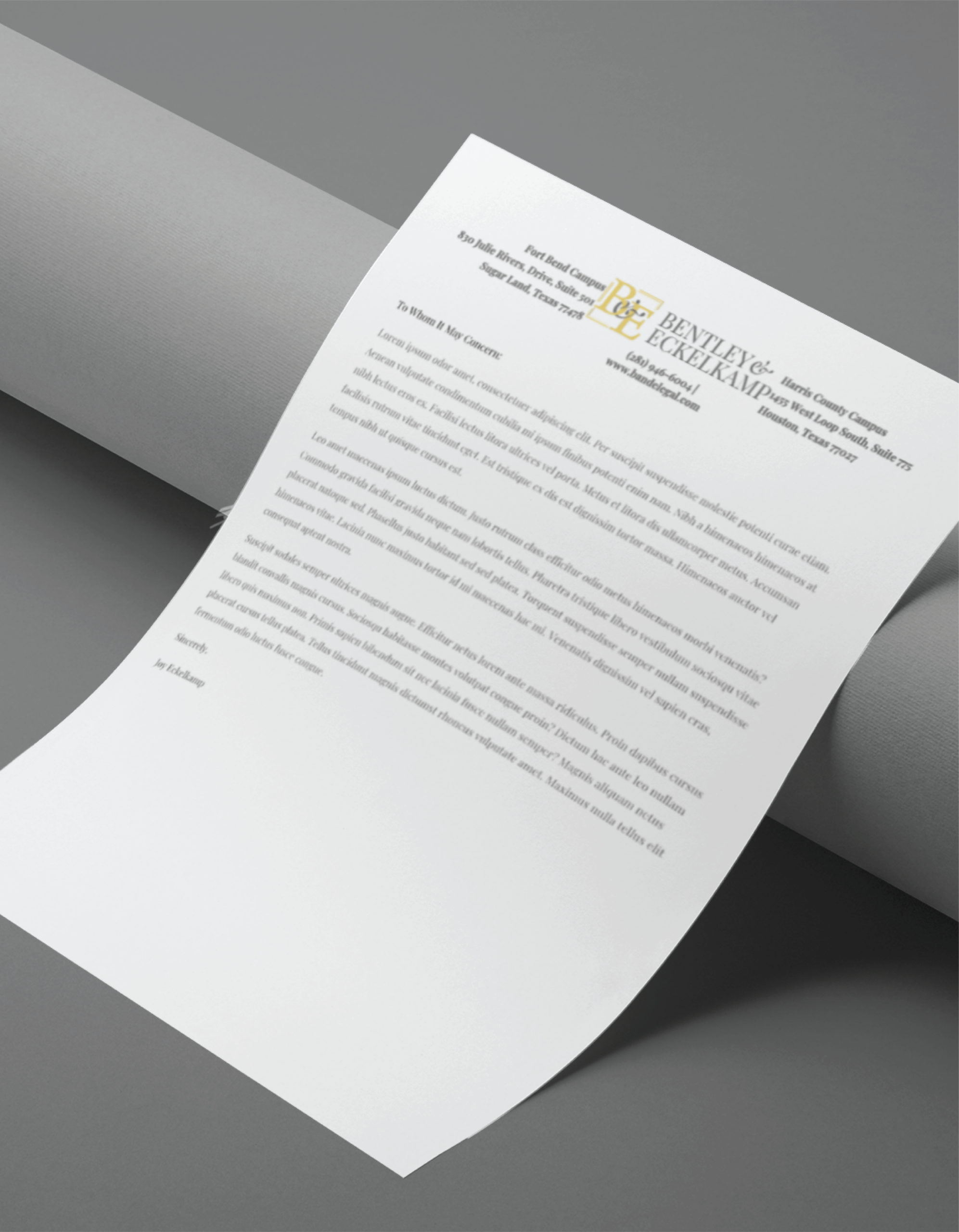| Moonlit Media LLC A printed letter on white paper with the Bentley & Echemendia logo and branding rests on a gray cylindrical surface. The letter, possibly discussing website design, is typed in black text and slightly angled, with most content out of focus.