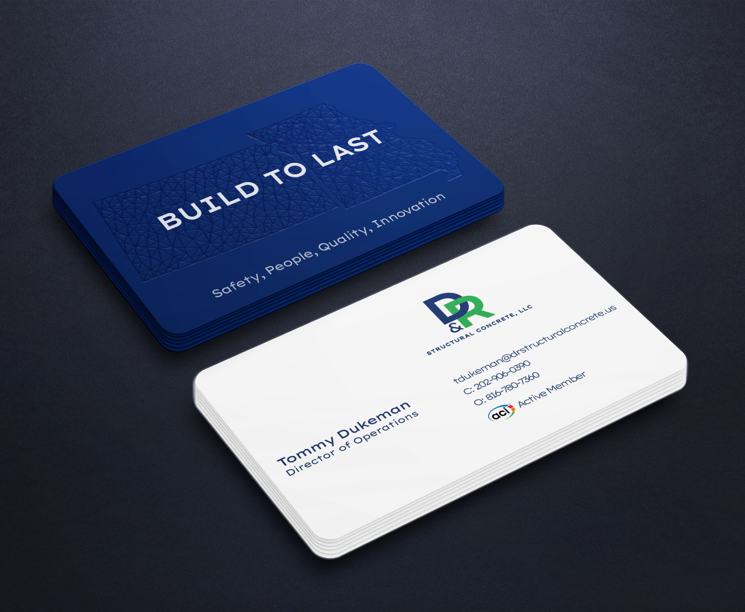 A stack of business cards; the top blue card, created by Moonlit Media, reads BUILD TO LAST with a geometric pattern and the words Safety. People. Quality. Innovation. The white card below features contact info for Tommy Dukeman at D&L Reinforced Concrete, LLC.