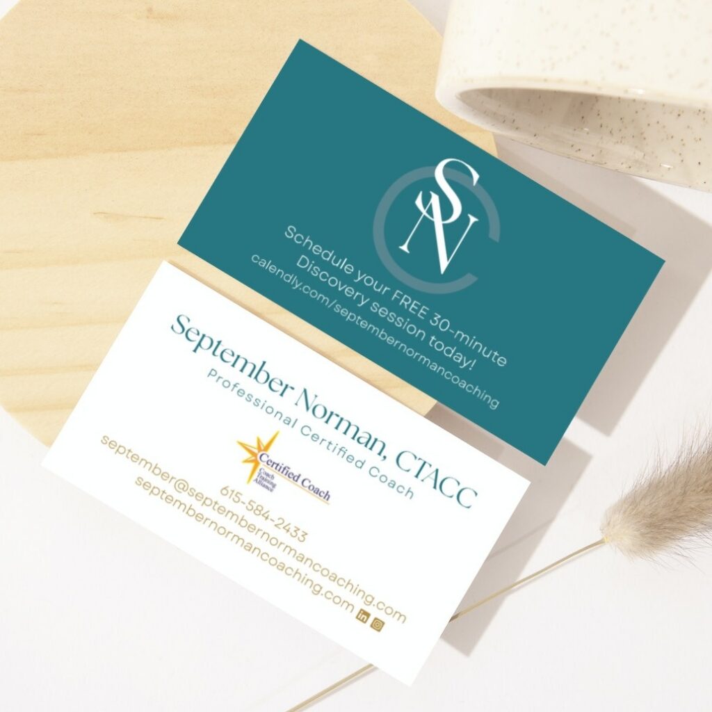 Two Custom Business Card Designs for September Norman, CTACC, a professional Life Coach—one teal with monogram and booking info, the other white with contact details and Certified Coach logo—styled on a light surface with Tenne-inspired decor.