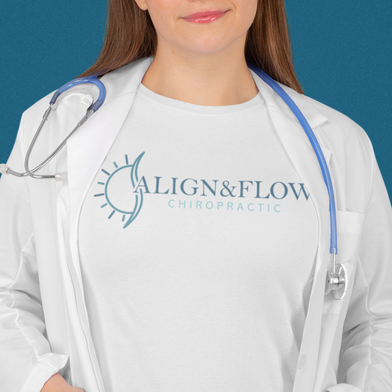 A woman in a white lab coat and stethoscope wears a shirt that reads ALIGN & FLOW CHIROPRACTIC, featuring a custom logo design with a stylized sun and spine. The background is solid teal.