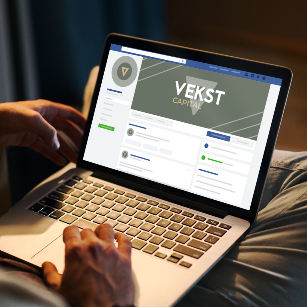 A person using a laptop, viewing a Facebook business page for VEKST CAPITAL with a green cover image and profile icon, sits comfortably with the screen in focus, exploring web design tips for a beauty salon in South Carolina.