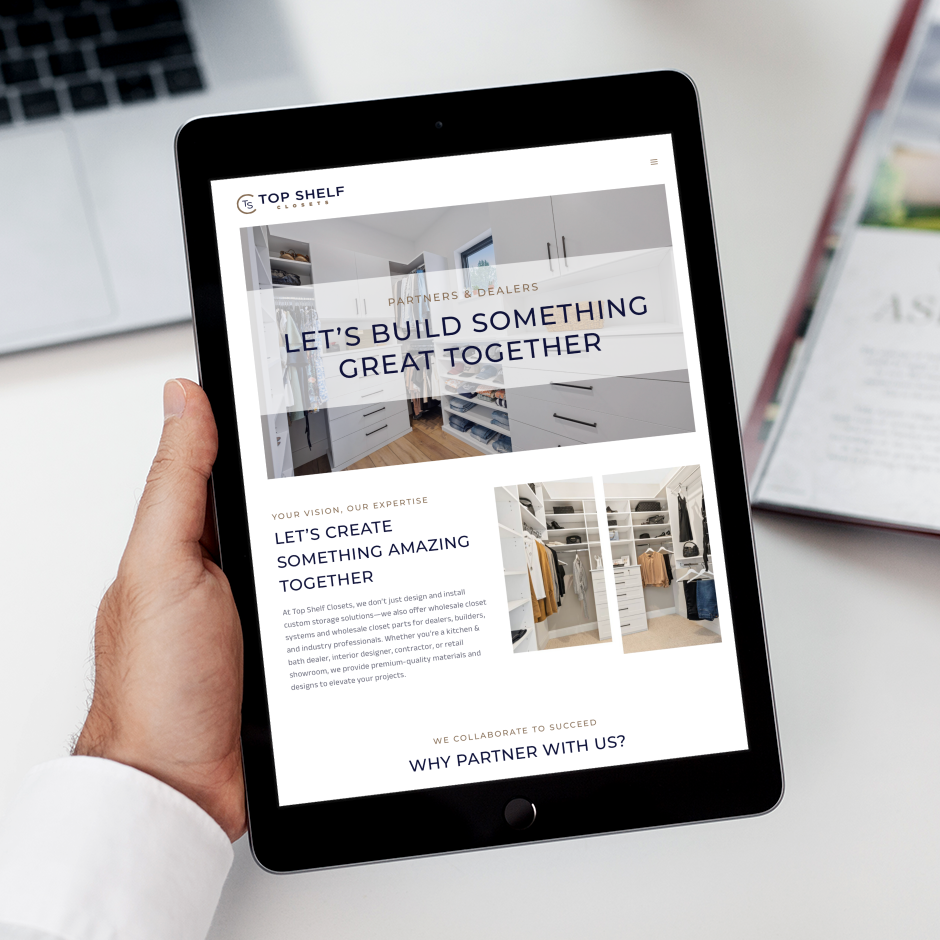 A person holds a tablet displaying a custom web design for Top Shelf Closets in Pennsylvania, featuring sleek closet designs and bold text, "Let's build something great together." A magazine and glass of water are in the background.