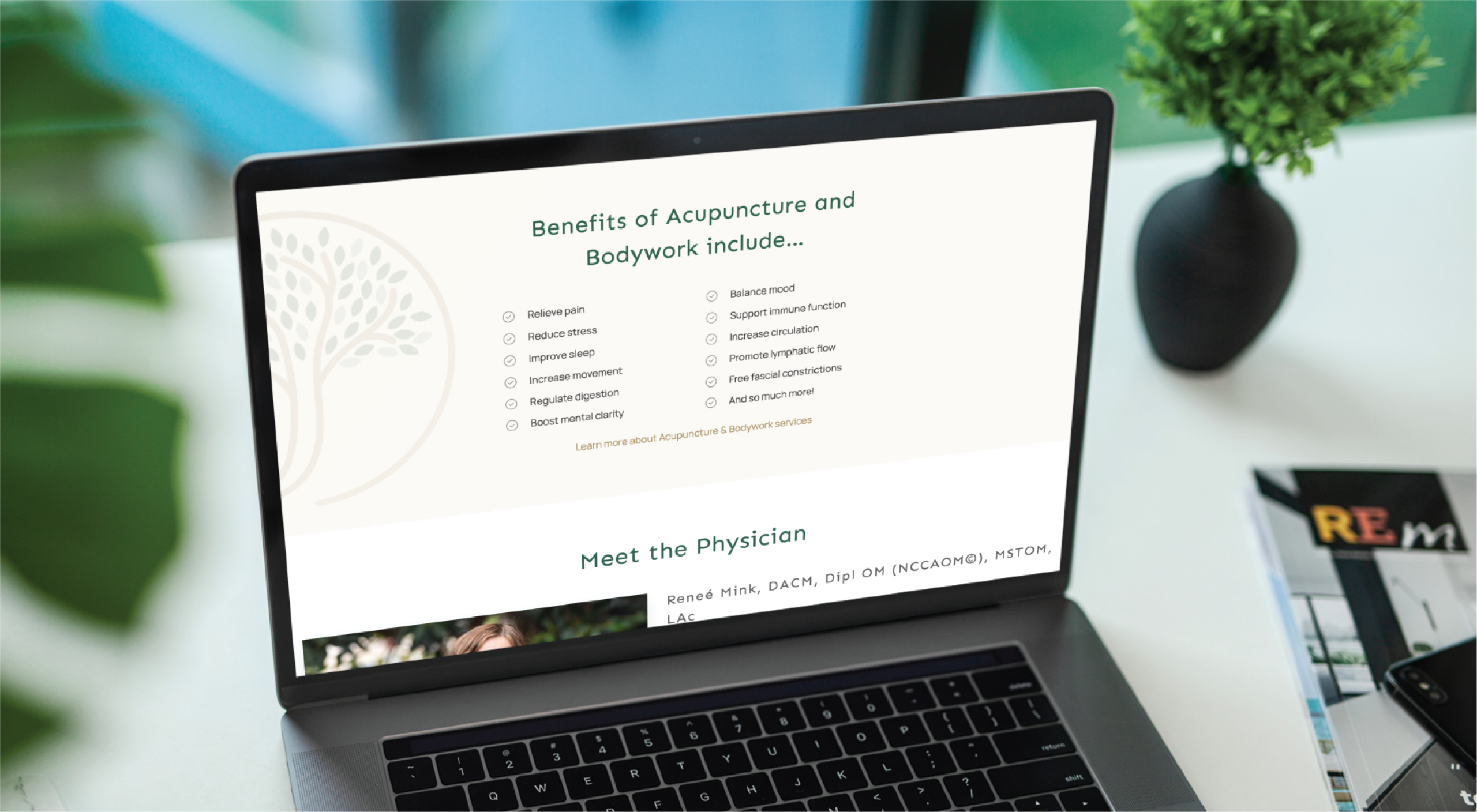 A laptop displays a website section titled Benefits of Acupuncture and Bodywork include... with a bulleted list of benefits. The screen also shows Meet the Physician, highlighting Support Services in Florida. A plant and a magazine are nearby.