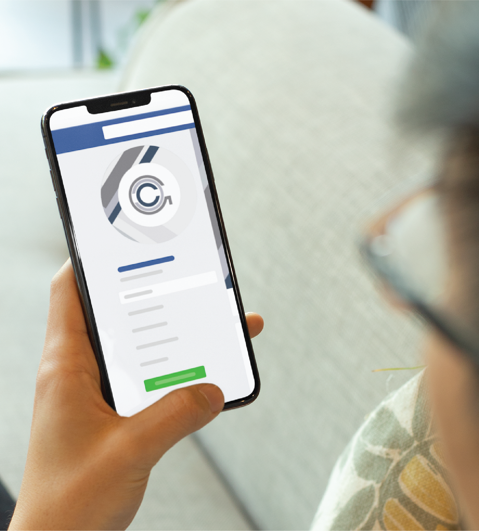 A person in Minnesota holds a smartphone displaying a loading or refreshing screen on an HR Management app, with blurred profile information and a green button visible.