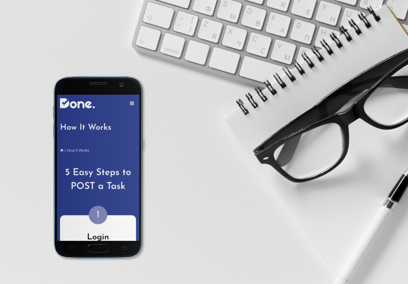 A smartphone displaying a Done. How It Works webpage is placed next to a white keyboard, a spiral notebook, black eyeglasses, and a pen on a white desk—highlighting tools to fix website issues or manage ads efficiently.