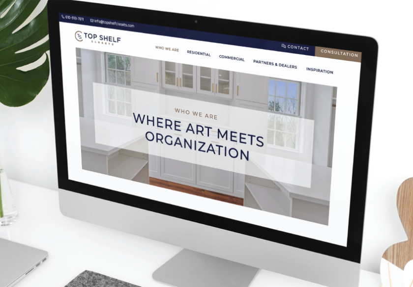 A computer monitor displays a trustworthy website for Top Shelf Results with the tagline Where art meets organization over an image of organized white shelves and cabinets. The site menu appears at the top, highlighting small business website design in Pennsylvania.