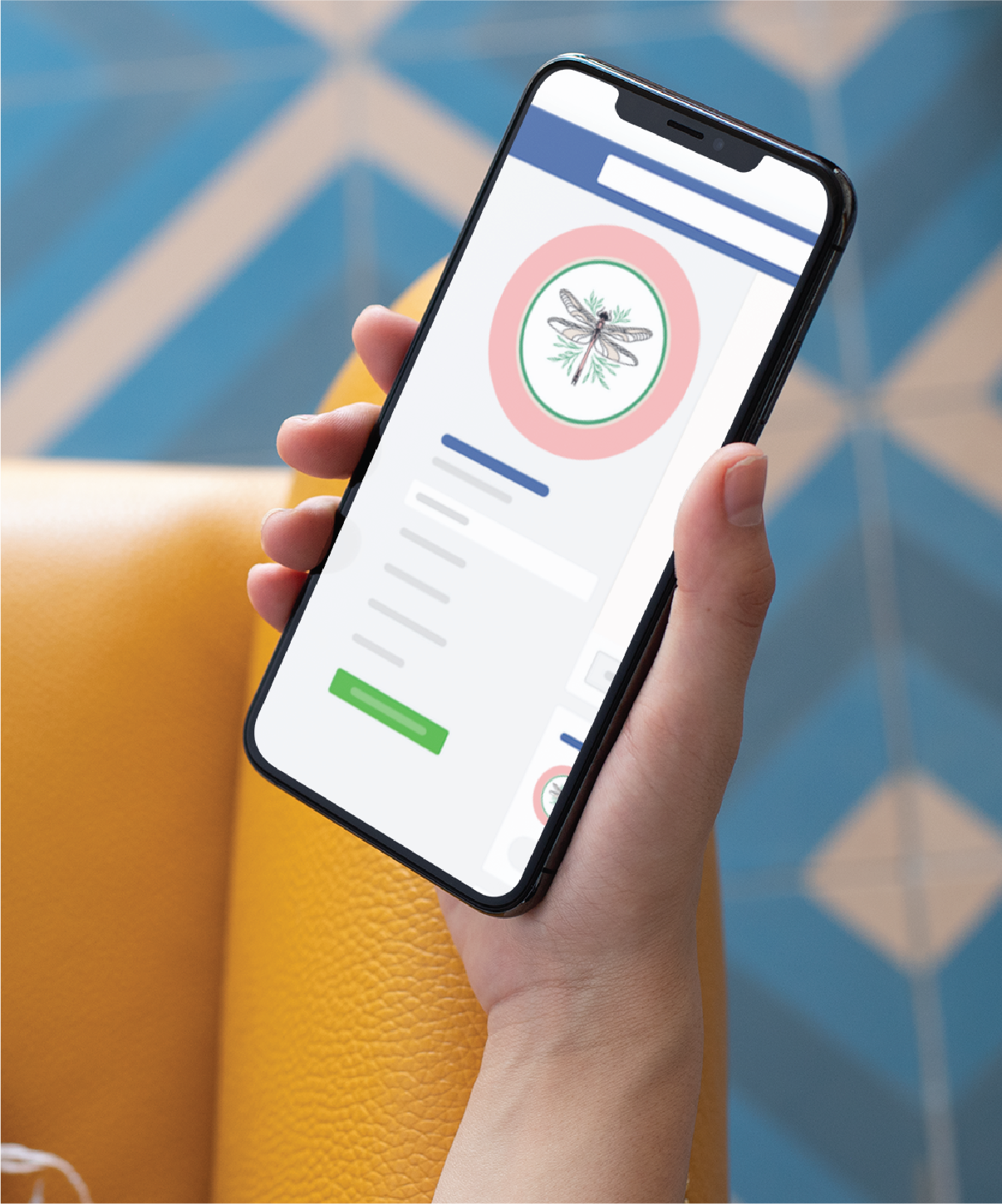 A hand holds a smartphone displaying a profile page with a dragonfly image as the profile picture, set against blue and beige geometric floor tiles—perfect inspiration for an Interior Designer’s social graphics in sunny Florida.