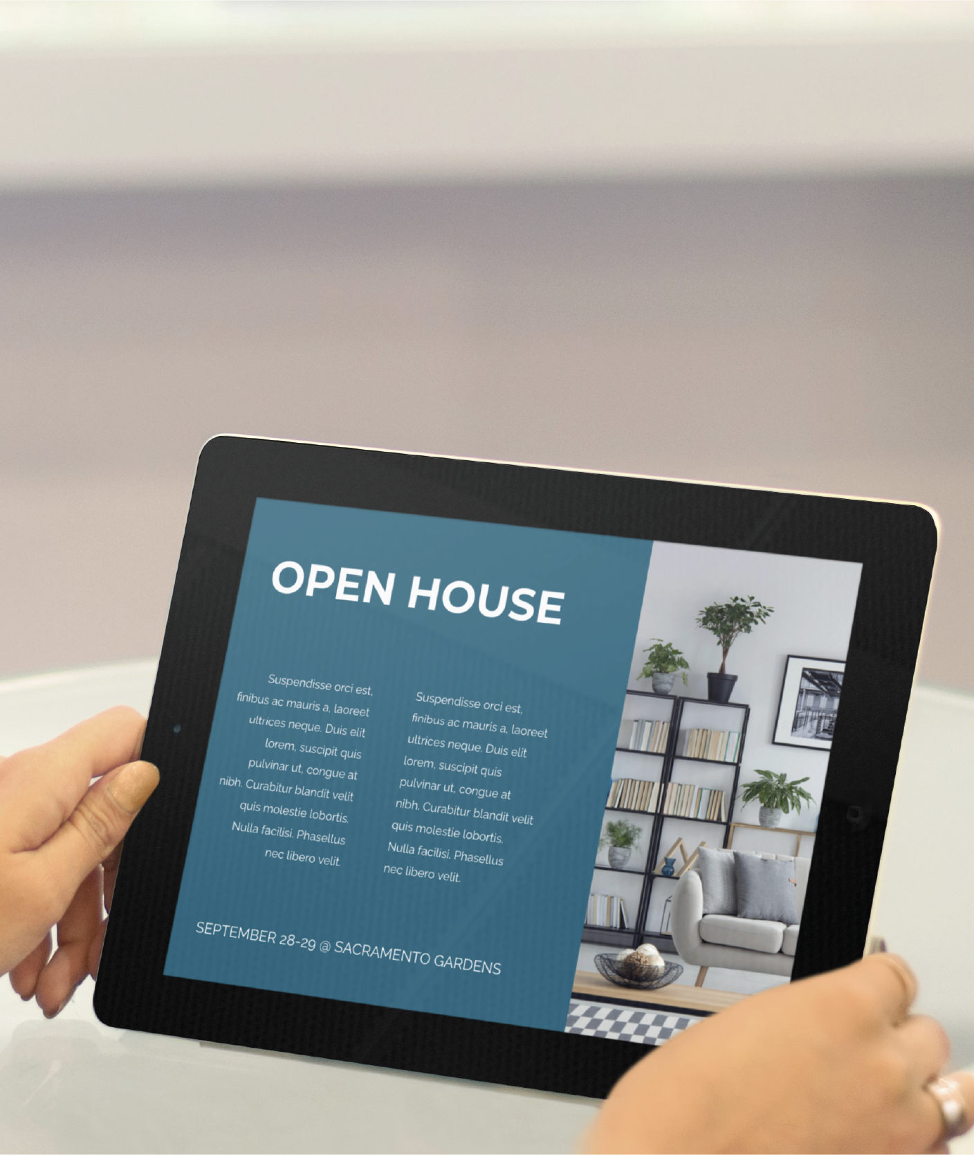 A person holds a tablet displaying an Open House invitation with event details, featuring Social Graphics on a blue background and a modern California living room photo with a bookshelf and plant on the right.