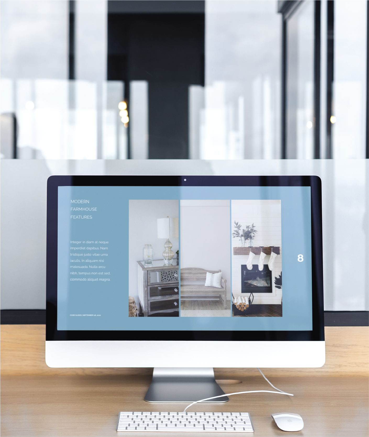 A desktop computer on a wooden desk displays a webpage featuring modern farmhouse decor, ideal for California realtors. Images of a bench and fireplace are shown, with social graphics visible. A mouse and keyboard sit nearby, framed by a glass office partition.