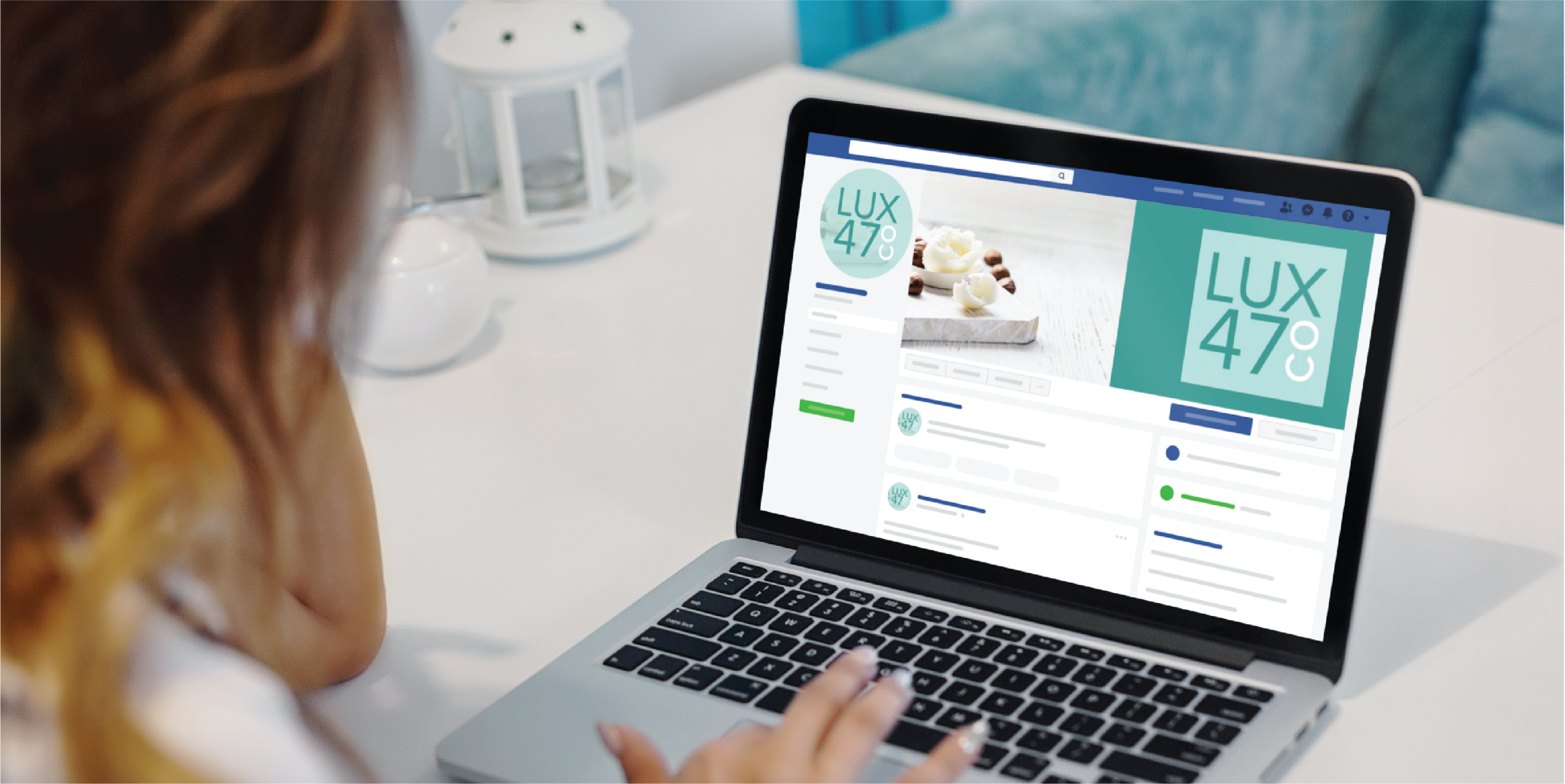 A person uses a laptop at a white desk, viewing Social Graphics for LUX 47°—a California brand—featuring an ice cream image and a teal logo. A white lantern sits in the background.