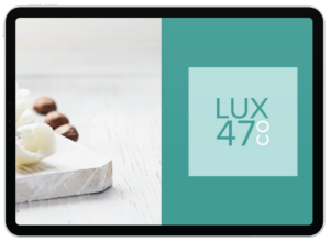 A tablet screen displays a split view: the left shows a marble board with white flowers and brown nuts on light wood; the right displays the LUX 47 CO logo on aqua backgrounds, perfect for California realtors seeking stylish social graphics.