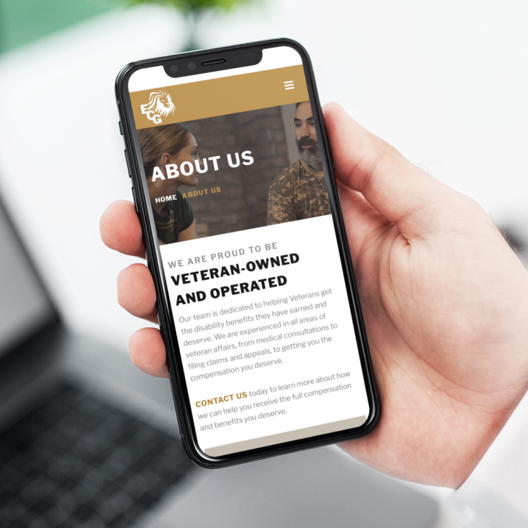 A hand holds a smartphone displaying a Texas-based business’s About Us page, highlighting that it is veteran-owned and operated. The text mentions supporting veterans with medical consultations and disability benefits.
