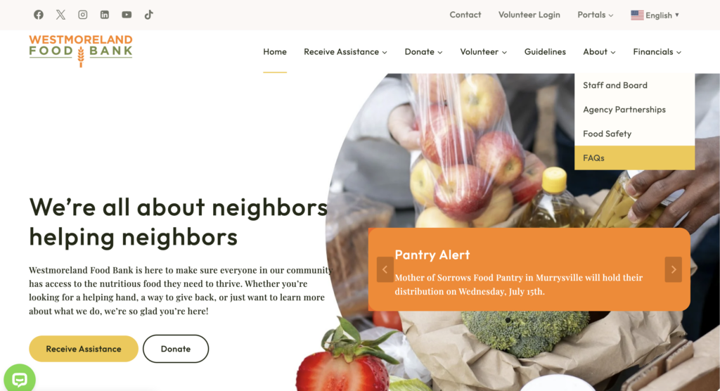 Westmoreland Food Bank homepage hero showing a grocery bag with produce and a large bold headline about neighbors helping neighbors.
