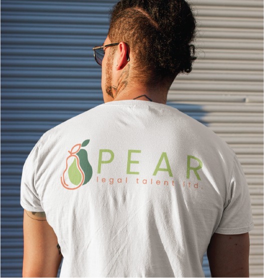 A person with sunglasses and a tattoo on their neck is shown from behind in Toronto, wearing a white t-shirt with a green and orange pear logo and the text PEAR legal talent ltd.
