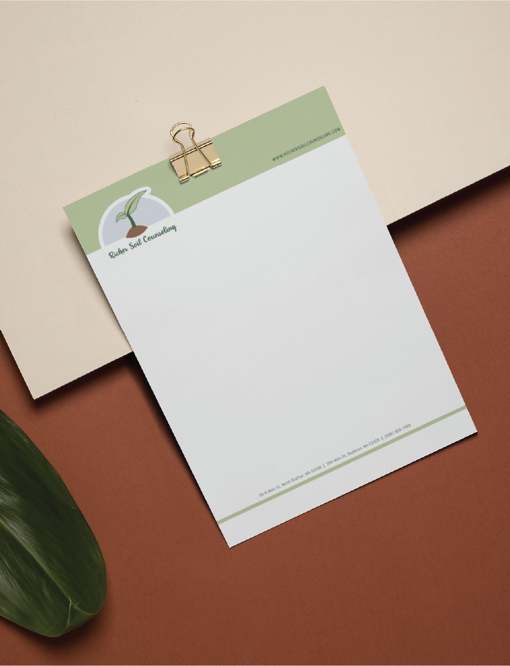 A blank letterhead with a green and white design, featuring a bird logo, Ruben Seal Consultancy, and contact details—enhanced with refined stationery design for sports performance coaching in California—clipped with a gold binder on a two-tone background with a green leaf.