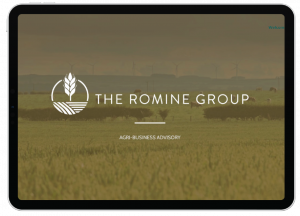 A tablet screen displays The Romine Group Agri-Business Advisory with a farm logo over a field and wind turbines in the background, showcasing innovative social media design inspired by California’s vibrant agricultural landscape.