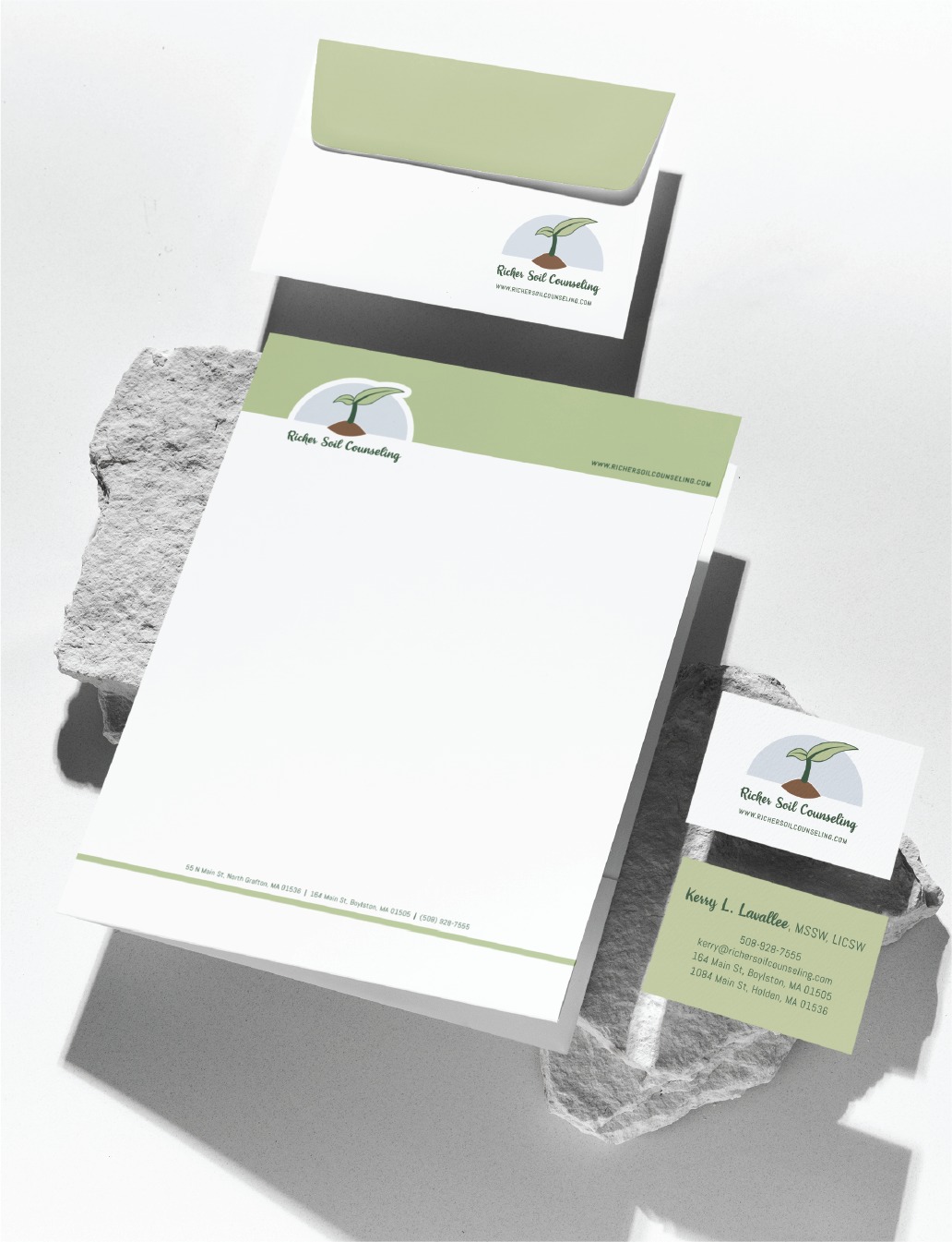 Green and white business stationery set for Robin Seal Counseling on textured stone. This sophisticated stationery design, inspired by California’s modern aesthetic, includes an envelope, letterhead, and business card with a leaf logo and contact details—perfect for professionals in counseling or sports performance coaching.