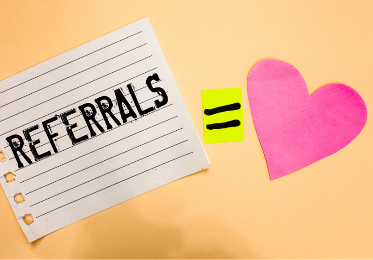 A note with REFERRALS written on it, an equals sign on a yellow paper, and a pink heart on a peach background, symbolizing that customer referrals are valued or appreciated.